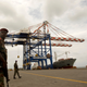 FILE PHOTO: A Djibouti policeman stands guard during the opening ceremony of Dubai-based port operator DP World's Doraleh container terminal in Djibouti port February 7, 2009.